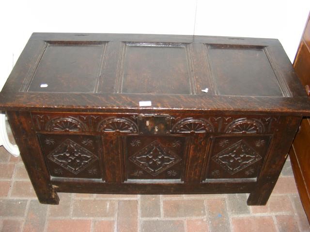 A period oak panelled coffer with carved front - 1