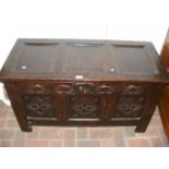 A period oak panelled coffer with carved front - 1