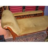 A Victorian chaise lounge in gold velour material