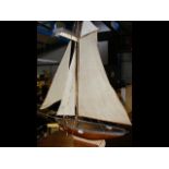 An antique wooden pond yacht on stand - 104cms hig