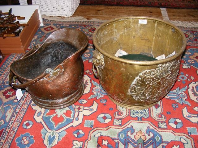 A brass coal bucket together with copper coal helm