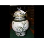 An Oriental green glazed baluster vase and cover -