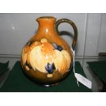 A Moorcroft Pottery jug with 'grape' design - 16cm