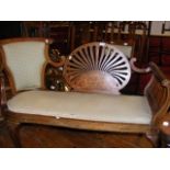 An Edwardian settee with shaped back rest and inla