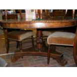 An early 19th century circular dining table with g