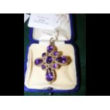 An antique ladies amethyst and yellow metal cross