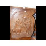 A carved Oriental wooden panel depicting family sc