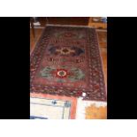 An antique Middle Eastern rug with geometric borde