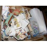 A box containing collectable cigarette cards and s