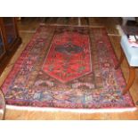 An antique Middle Eastern rug with geometric borde