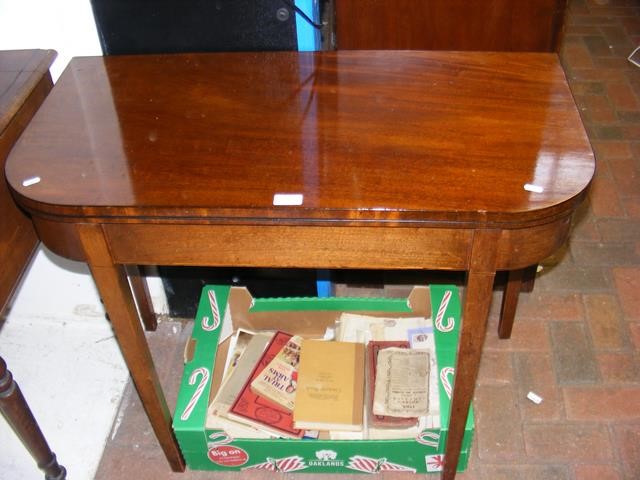 A 19th century mahogany fold over games table