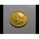 A 1911 gold half sovereign coin