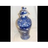 An antique blue and white baluster vase and cover