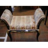 A black and gilt antique window seat