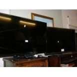 A small Sony flatscreen TV with remote, together w