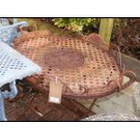 A decorative wrought iron garden tray table