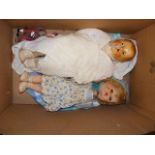 A vintage celluloid doll together with others