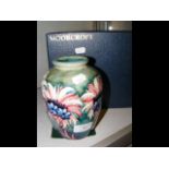 A Moorcroft Pottery vase with tube line floral dec