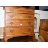An antique small proportioned chest of four gradua