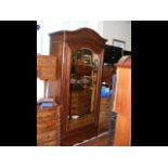 An antique French wardrobe with bevelled mirrored