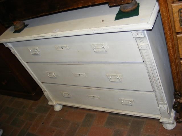 An antique French cream painted chest of three lon