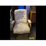 A Victorian armchair with button back and turned f