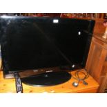 A Samsung flatscreen TV with remote