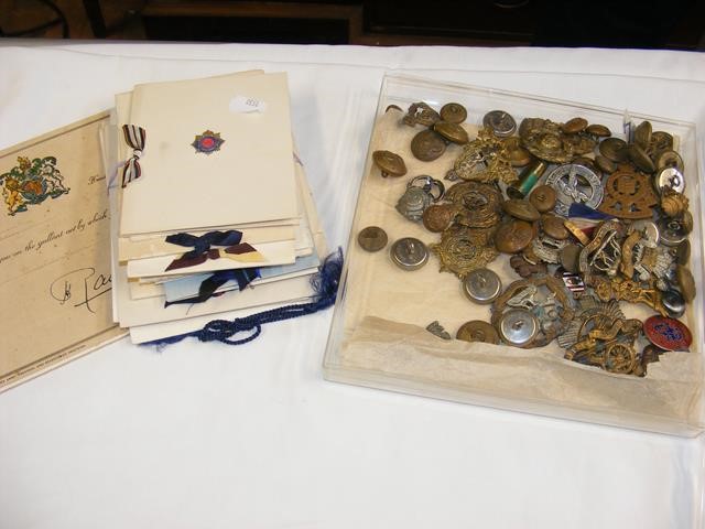 A selection of military badges, buttons etc