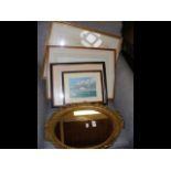 An oval wall mirror together with watercolours and