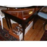 A Georgian mahogany triangular drop leaf table