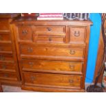 A stained pine chest of drawers