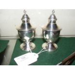 A pair of 10cm high silver salt and pepper pots