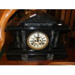 An antique slate and marble mantel clock with visi
