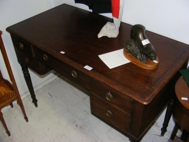 A 19th century mahogany writing desk with five dra