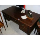 A 19th century mahogany writing desk with five dra