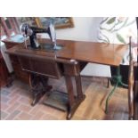 A treadle Singer sewing machine in oak case with original fitments and manual