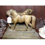 A pair of cast brass horse door stops