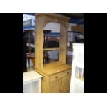 An antique pine dresser with drawer and cupboards