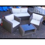 A three piece rattan patio set with table