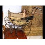 A Victorian doll's pram, complete with old doll