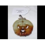 A jade pendant with silver mount - 5.5cm diameter,