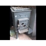 A cast metal stove - 64cms high