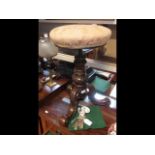 A Victorian revolving piano stool