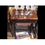 A Victorian rosewood work table with sliding drawe