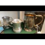 A silver tankard together with two others