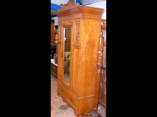 A hardwood mirrored door wardrobe with one drawer