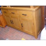 A 150cm light oak sideboard with three drawers and