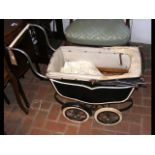 A vintage dolls pram together with two night dress