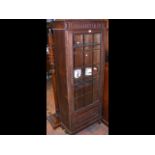 A bookcase/display cabinet with glazed door