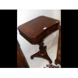 A 19th century mahogany work table on shaped suppo